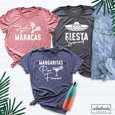 three t - shirts that say margaritas and fiesta are on display next to some palm leaves