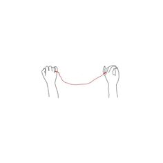 two hands are pulling a string with one hand and the other is holding something red