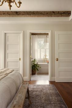 a bed sitting in a bedroom next to a doorway