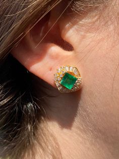 "Pacific Jewelry Presents, Vintage natural Colombian Emeralds, featuring two exquisite square cut Emeralds weighing approx. 1.70 carats (total) and adorned with lively colorless natural diamonds. Diamonds are an assortment of baguette and round cut, approx. 1.35 carats (total). These beautiful earrings are mounted in 18k yellow gold, and have a safe push back closure made in 14k gold for extra strength and durability. The Emeralds are of the highest quality and are untreated. The deep \"muzo gre Luxury Gia Certified Yellow Gold Earrings, Gia Certified Luxury Yellow Gold Earrings, Luxury Yellow Gold Cluster Earrings With Gemstones, Formal Baguette Cut Emerald Earrings, Formal Baguette-cut Emerald Earrings, Formal Yellow Gold Diamond And Emerald Earrings, Elegant Green Baguette Cut Earrings, Luxury Emerald Earrings In Emerald Cut, Elegant Gia Certified Emerald Earrings