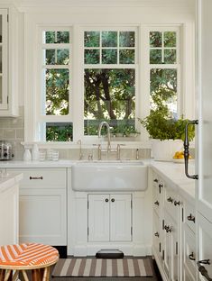 a white kitchen with black and white checkered flooring