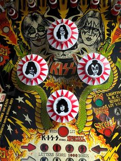 the buttons on this pinball machine are decorated with images of rock and roll band members