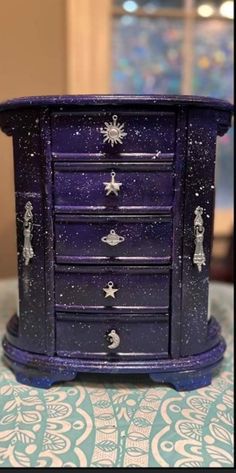 a purple and blue dresser sitting on top of a table