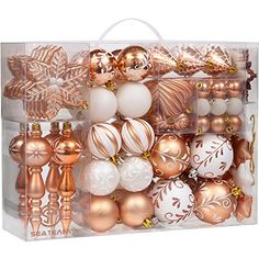 an assortment of christmas ornaments in a clear gift bag with gold trimmings on the bottom