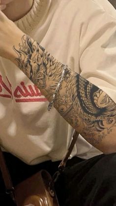 a man with a dragon tattoo on his arm