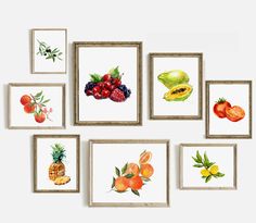 a bunch of pictures hanging on the wall with fruit in them and one has a pineapple