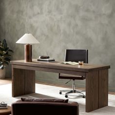 an office desk with a lamp and chair in front of the desk is made out of wood