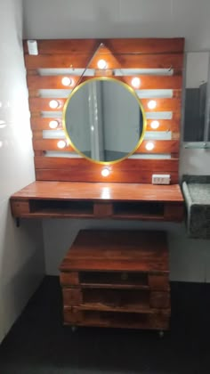 a vanity with a mirror and lights on it