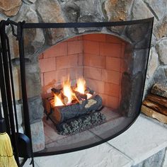 a fireplace with fire and logs in it