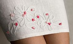 the back of a woman's skirt with red hearts on it and white fabric