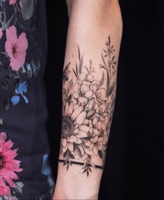 a woman with a flower tattoo on her arm