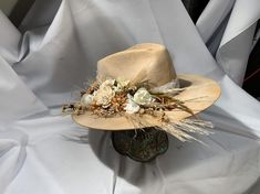 Road Warrior Custom Bridal HatFlowers can be of the color of your choosing.Available in tan or cream.4 1/2 Crown, 3 3/4 BrimCustom Color, Distressing, Band and AccessoriesAlthough each hat is unique a similar hat can be made in various sizes. Size ChartSmall - 6 7/8 Medium - 7 1/8Large - 7 3/8XL - 7 5/8XXL- 7 3/4All Sales Final Custom Kentucky Derby Costume Hat With Flat Brim, Rustic Handmade Hat For Kentucky Derby, Handmade Rustic Fedora For Kentucky Derby, Custom Curved Brim Costume Hat For Festivals, Custom Curved Brim Festival Costume Hat, Handmade Western Costume Hats For Kentucky Derby, Handmade Western Hats For Kentucky Derby, Custom Costume Hat With Curved Brim For Festivals, Custom Festival Costume Hat With Curved Brim