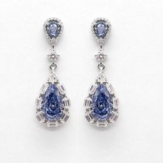 These exquisite earrings are made of S925 silver and set with cultivated blue diamonds, presenting a noble and elegant temperament. The earrings are exquisitely designed, topped with a teardrop-shaped blue diamond and surrounded by a ring of sparkling white diamonds. The lower part is hung with a larger teardrop-shaped blue diamond, surrounded by trapezoidal cut white diamonds, creating a gorgeous decorative effect. The earrings not only highlight the nobility and uniqueness of blue diamonds, bu Blue Diamond Earrings, Teardrop Diamond, Blue Diamonds, Silver Ring Set, Classic Metal, Unique Handmade Jewelry, White Accents, Cartilage Earrings, Gold Plated Earrings