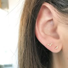 a close up of a person wearing ear piercings