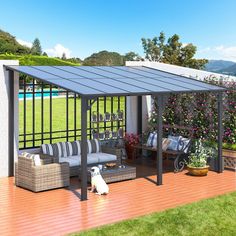 a dog is sitting on the wooden deck next to an outdoor living area with furniture