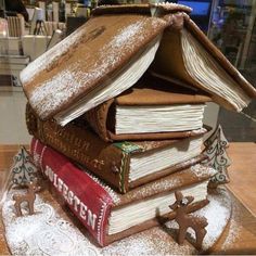 a stack of books sitting on top of a wooden table covered in powdered sugar