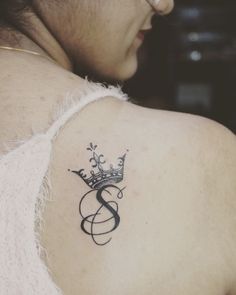 a woman with a crown tattoo on her shoulder