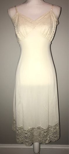 - Lovely 80's ivory bridal slip - No tags, but measures to a medium - see measurements below - NOTE: small tear in the lace near one of the straps - see picture - NOTE: small pullings in the lace, normal for age - Lace detailing around chest and hem Measurements: Chest: 34" Waist: 28" Hips: 37" Length: 38" PLEASE NOTE: - all items are pre-owned and may have normal wear and wash - vintage sizes are different and may vary / I'll try my best to include measurements or have models try on items  SHIP Fitted Camisole Slip Dress For Wedding, White Sheer Evening Slip Dress, White Sheer Slip Dress For Evening, Fitted Slip Dress With Lace Trim For Wedding, Fitted Lace Trim Slip Dress For Wedding, Cami Slip Dress With Delicate Straps For Wedding, White Lace Trim Slip Dress For Evening, Fitted Cream Slip Dress For Wedding Night, Fitted Wedding Slip Dress With Lace Trim