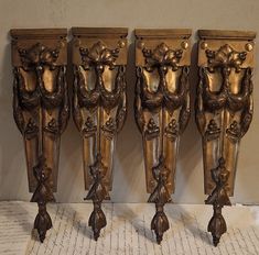 three ornately carved wooden vases sitting next to each other