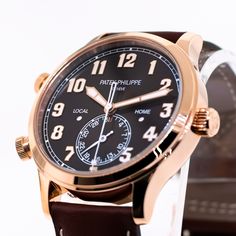 Description Guaranteed Authentic Men's Patek Philippe Calavatra Pilot Travel Time with a 42mm 18K rose gold case and a brown sunburst Arabic dial. This fine timepiece features a home day and night indicator, gold luminescent numerals, a date indicator, and a brown calfskin strap. This watch is unworn with tags and its box. It comes with a Two Year Warranty from Da Vinci Fine Jewelry, Inc., a Patek Philippe box, instructions, and certified retail appraisal from Da Vinci Fine Jewelry, Inc. Details Designer Brown Watch For Business, Luxury Watches With Polished Finish And Round Dial, Luxury Brown Business Watches, Luxury Brown Business Watch, Brown Watch Accessories With Polished Round Dial, Brown Polished Finish Watch Accessories With Round Dial, Timeless Brown Watch With Polished Finish, Designer Brown Watches With Diamond Hour Markers, Timeless Brown Watches With Polished Finish