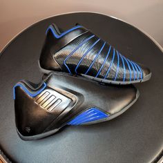 a pair of black and blue shoes sitting on top of a table