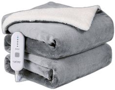 two blankets stacked on top of each other with a thermometer attached to them