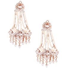 Editor's Note For the love of flexibility and fluidity, endless strands of lustrous pearls, the Swings of Paradise Chandelier Earrings epitomises grace and elegance. Delightfully capturing fluidity, the luxurious power jewel has been artfully sculpted with accents of faunal sighting with a playful mix of Carved melon droplets and Pearl white enamel. Delicately handcrafted to perfection, luxury par excellence, the Earrings are a statement in itself. Material: Brass Plating: 22 KT Rose Gold Care: Outhouse Jewellery, Shell Choker, Charms Necklace, 22 Carat Gold, Bridal Event, White Enamel, Buy Dress, 22k Gold, Baroque Pearls