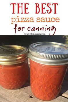 two jars filled with pizza sauce sitting on top of a wooden table next to each other