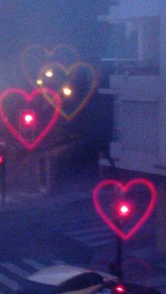 two heart shaped lights in the street at night