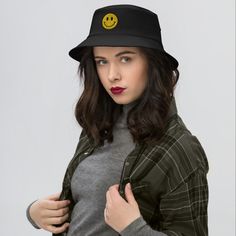 This is our Acid House V2 bucket hat with the notorious smiley face. It has a simplistic and cool look: If you are a sesher, you would know... This bucket hat is a combination of timeless practicality and vintage style. Perfect for fishing, hiking, and 80s-90s nostalgia.  * 98% cotton, 2% spandex * Mid-profile hat with a high-profile embroidery area  * 3″ crown * Matching undervisor * Premium Flexfit sweatband * One size fits most * Head circumference: 21 ⅝″-23 ⅛″ (55 cm-58.7 cm) * Blank product Kanji Love, Crop Top Blanc, Embroidered Bucket Hat, Fun City, Vintage Airplane, Mens Bucket Hats, Acid House, Vintage Airplanes, Shield Design