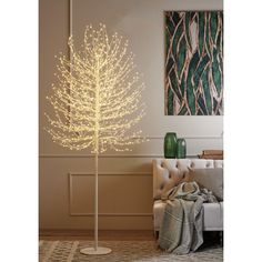 a white lighted tree in a living room