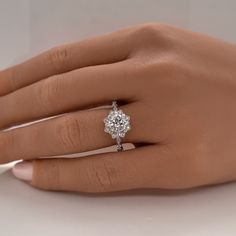 a woman's hand with a diamond ring on it