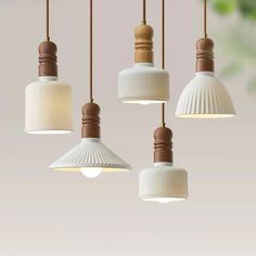 four white and brown lights hanging from a ceiling