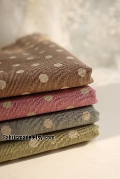 four different colored polka dot fabric on top of each other in various sizes and colors