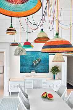 a dining room with lots of colorful lights hanging from the ceiling