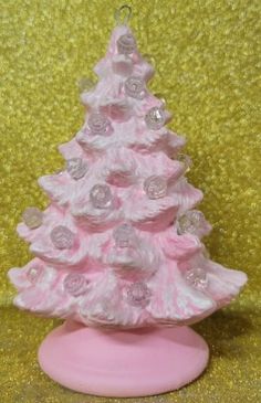 a pink and white ceramic christmas tree ornament