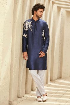 Navy kurta with mandarin collar, placement floral, bird pattern and silver zari dori thread embroidery. Paired with contrast pant.
Components: 2
Pattern: Embroidered
Type Of Work: Zari Dori Thread Work
Neckline: Mandarin Collar
Sleeve Type: Full Sleeves
Fabric: M.B R Silk
Color: Blue
Other Details: 
Side slits on kurta
Kurta Closure: Front concealed button placket
Occasion: Mehendi and Puja,Sangeet - Aza Fashions Mans Kurta Embroidery Design, Men Kurta Embroidery Design, Men Embroidery Kurta Design, Mens Kurta Embroidery Designs, Trending Kurta For Men, Embroidery Kurta For Men, Mens Designer Kurta, Buta Design, Kurta Designs Men's