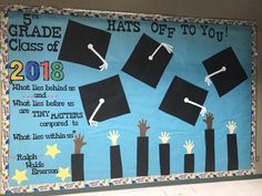 a bulletin board with graduation caps and hands in the air on blue background that says, grade 5 hats off to you