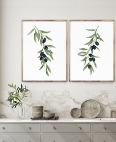 two olives are hanging on the wall next to each other in front of a dresser