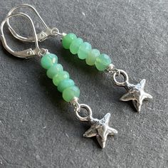 Bright beautiful faceted chrysoprase wired in sterling silver show off a sweet solid sterling silver artisan star. The approximate length is 1 7/8". The leverbacks shown are an upgrade. Please choose your earwire preference. Your jewelry will arrive beautifully giftboxed. Handmade Artisan Chrysoprase Jewelry, Adjustable Silver Jewelry With Chrysoprase, Green Star-shaped Handmade Jewelry, Nickel-free Chrysoprase Jewelry Gift, Handmade Chrysoprase Dangle Jewelry, Adjustable Silver Chrysoprase Jewelry, Handmade Green Star-shaped Jewelry, Nickel-free Silver Chrysoprase Jewelry, Green Chrysoprase Jewelry With Faceted Beads