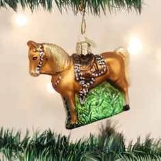 an ornament shaped like a horse is hanging from a christmas tree