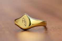 This delicate name initial ring is a beautifully crafted piece that combines elegance with a personal touch. The teardrop shaped design, perfect for showcasing a single initial, adds a unique twist to traditional jewelry styles. Made with high-quality materials, this personalized ring serves as a thoughtful gift for her, whether for birthdays, anniversaries, or just because. A meaningful gift that can be cherished every day, this custom ring is ideal for anyone who loves dainty, sophisticated je Classic Teardrop Rings For Gift, Modern Pear-shaped Rings As Gift, Pear-shaped Ring As Gift, Classic Pear-shaped Ring For Gift, Classic Pear-shaped Ring Gift, Classic Teardrop Rings With Polished Finish, Classic Teardrop Ring With Polished Finish, Gold Teardrop Rings With Polished Finish, Classic Teardrop Engraved Jewelry