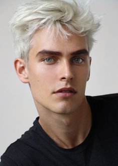 a young man with white hair and blue eyes