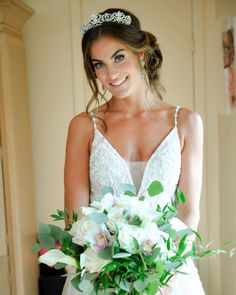 a woman in a wedding dress holding a bouquet