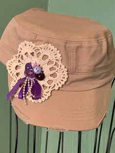 a hat with a purple ribbon and an octopus brooch on it's side