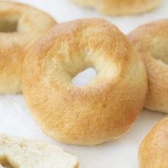 several bagels sitting on top of a white table