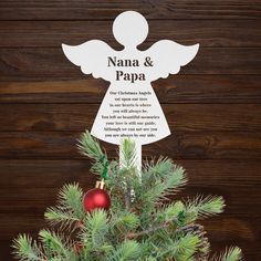 a christmas tree with an ornament hanging from it's top and the words nama & papa above it