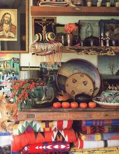 there are many different items on the shelf in this room, including plates and vases