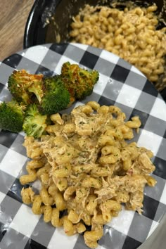 a plate with pasta and broccoli on it next to some other food items