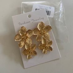 Gold Dangle Flower Earrings Gold Flower Clip-on Earrings For Spring, Gold Clip-on Earrings For Spring Party, Spring Party Gold Clip-on Earrings, Chic Metal Flower Earrings For Spring, Gold Flower Earrings, Gold Flower, Gold Flowers, Flower Earrings, Jewelry Earrings